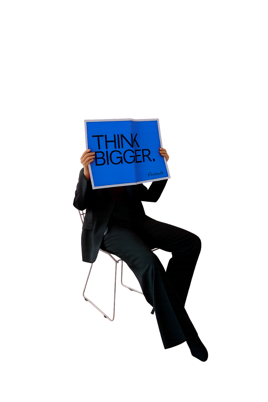 A seated person holding a blue Think Big sign